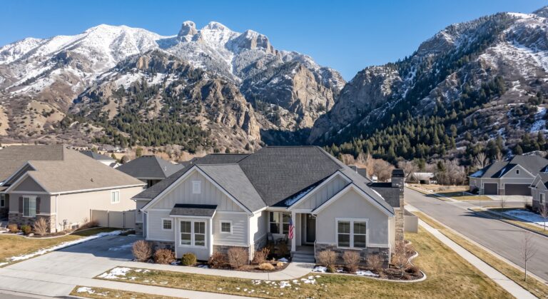 Sandy, Utah home with a new asphalt shingle roof at the base of the snow-capped Wasatch mountains